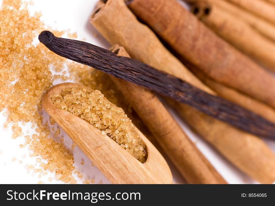 Cinnamon Sticks and vanilla bean on white - tight depth of field. Cinnamon Sticks and vanilla bean on white - tight depth of field.