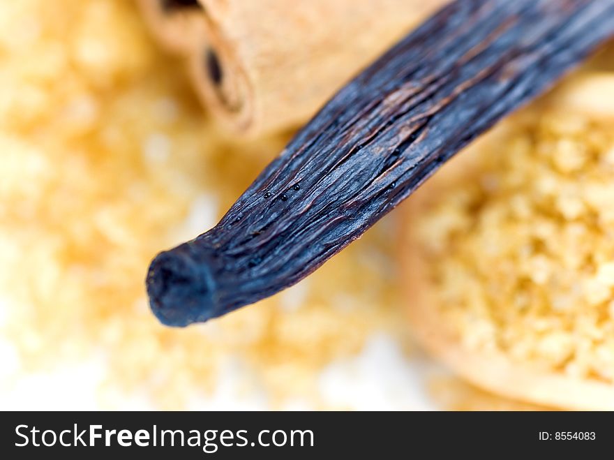 Cinnamon Sticks and vanilla bean on white - tight depth of field. Cinnamon Sticks and vanilla bean on white - tight depth of field.