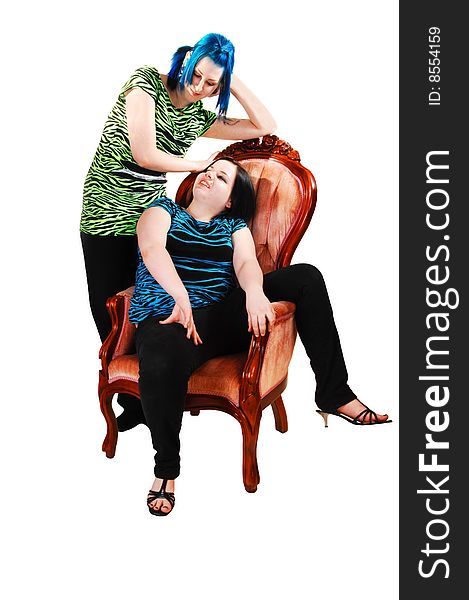 Two girlfriends, one sitting in a pink armchair and her friend standing
behind with nice blue hair on white background. Two girlfriends, one sitting in a pink armchair and her friend standing
behind with nice blue hair on white background.