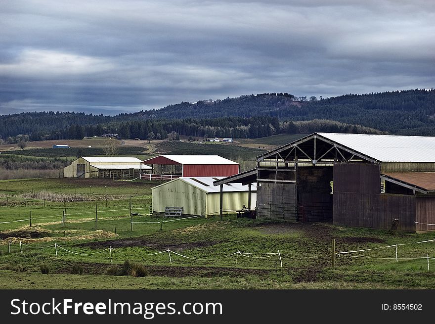 A nice farmland day in Oregon with stables and corrals.
