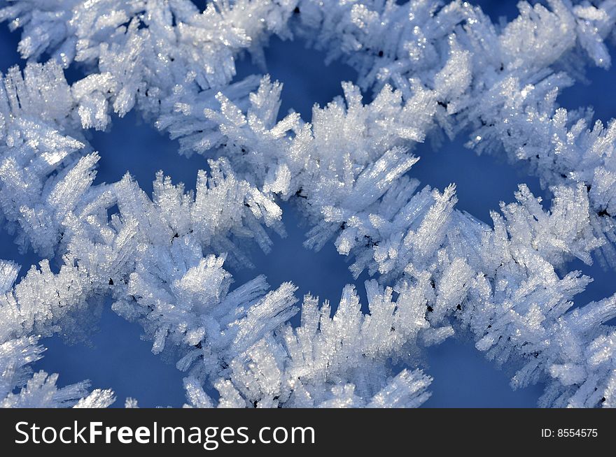 Fine ice crystals on netting formed by hoar frost