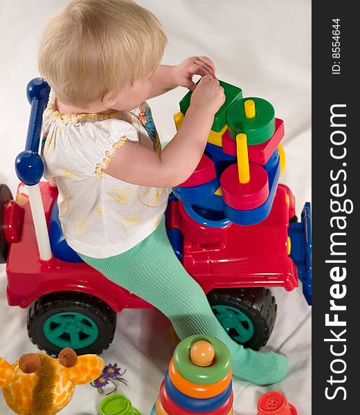 Child Sits On Toy