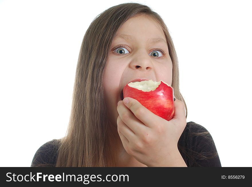 The cute little girl eating the apple. The cute little girl eating the apple