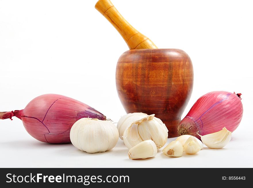 Garlic, onion and pestle on white background. Garlic, onion and pestle on white background