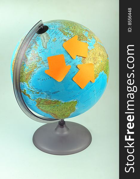 Recycle concept, three green arrow labels on Earth globe