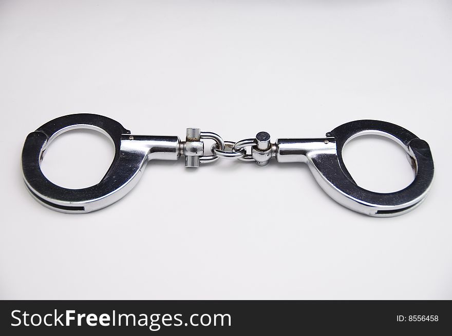 A close-up of handcuff with white background.