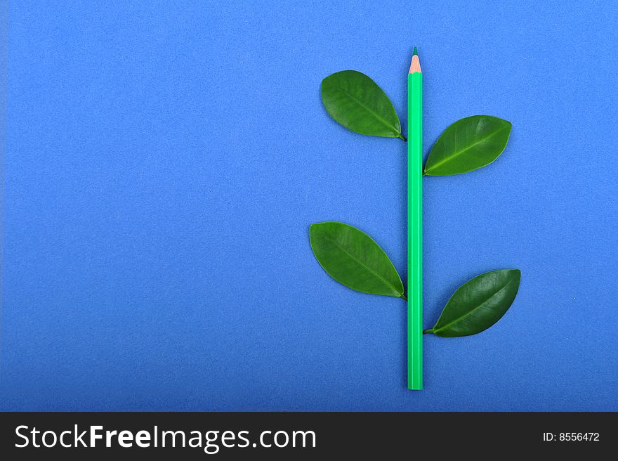 Green pencil wit leafage on blue background. Green pencil wit leafage on blue background
