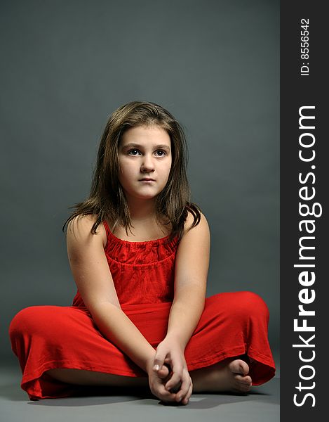 Studio portrait of a girl in red dress. Studio portrait of a girl in red dress