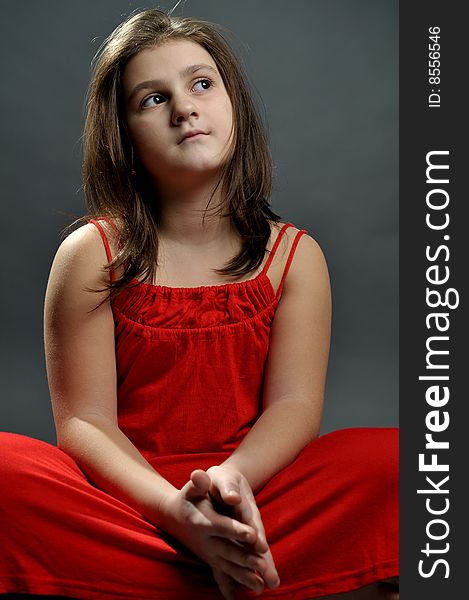 Studio portrait of a girl in red dress. Studio portrait of a girl in red dress