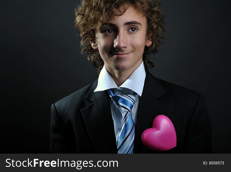 Young boy in suit with a hearth in pocket. Young boy in suit with a hearth in pocket