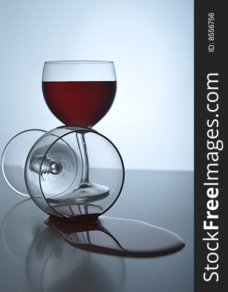 Red wine spilling out from a wineglass, close up. Red wine spilling out from a wineglass, close up