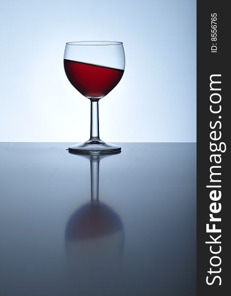 Glass with red wine standing oblique, close up. Glass with red wine standing oblique, close up