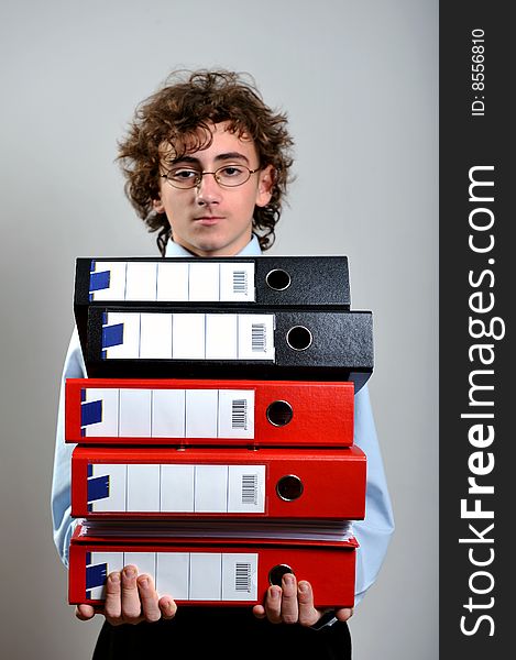 Young businessman holding a stack of folder in his hands. Young businessman holding a stack of folder in his hands