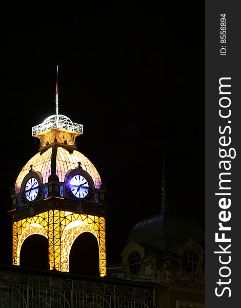 Central clock tower of industrial palace in Prague at night