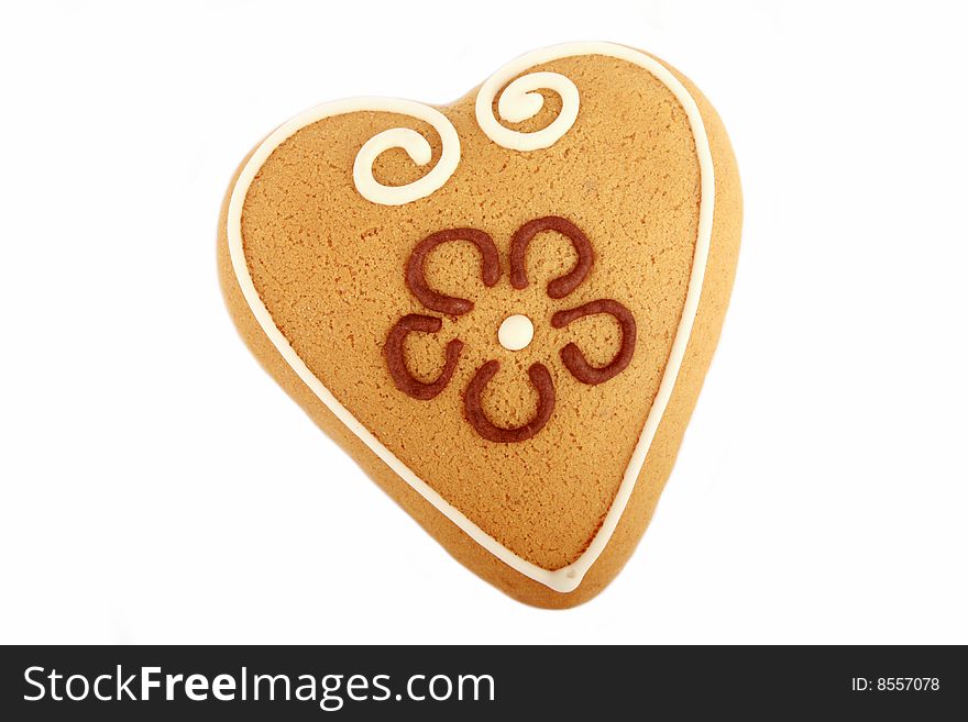 Heart shaped gingerbread cookie with flower decoration isolated