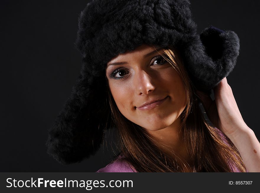 Woman in a fancy russian hat over black