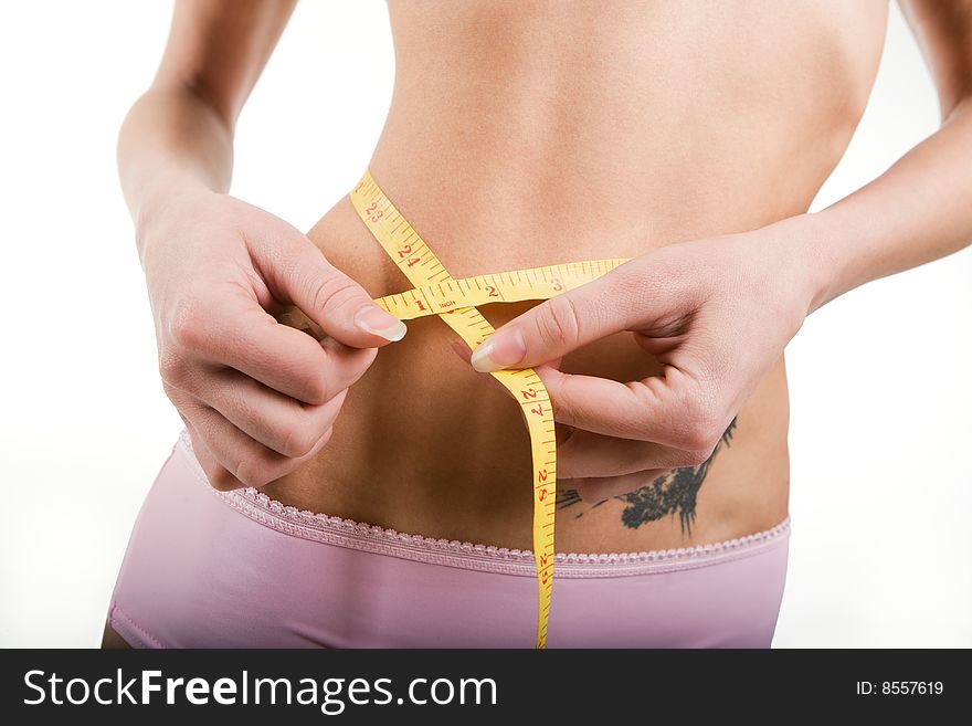 Slim girl measuring torso with tape, isolated