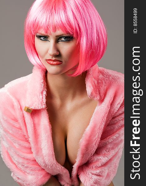Attractive woman wearing red fur coat and magenta wig. Attractive woman wearing red fur coat and magenta wig