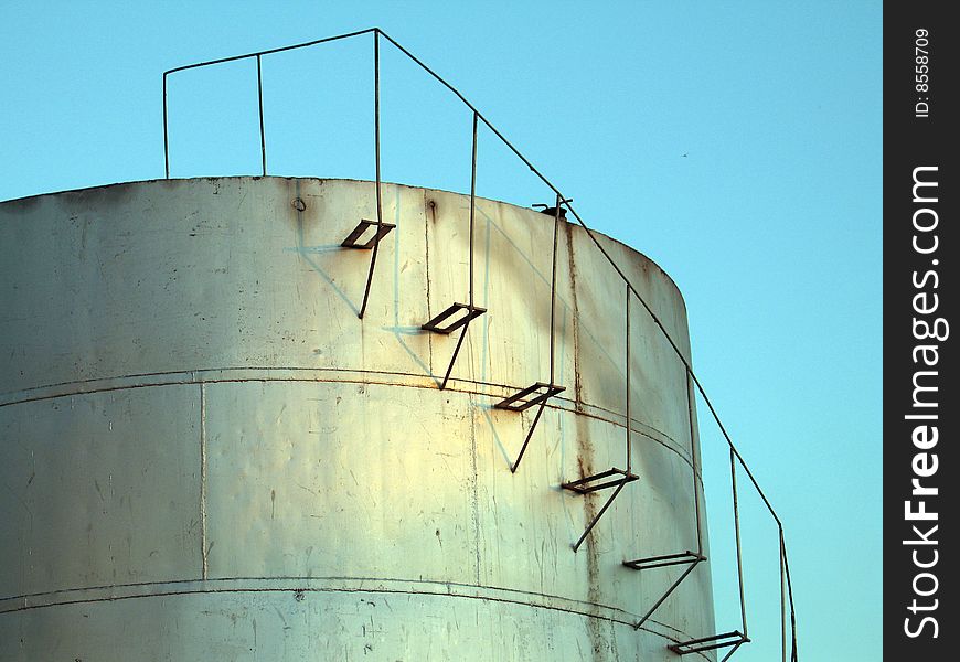 Cylindrical fuel storage tanks with staircase running along the side