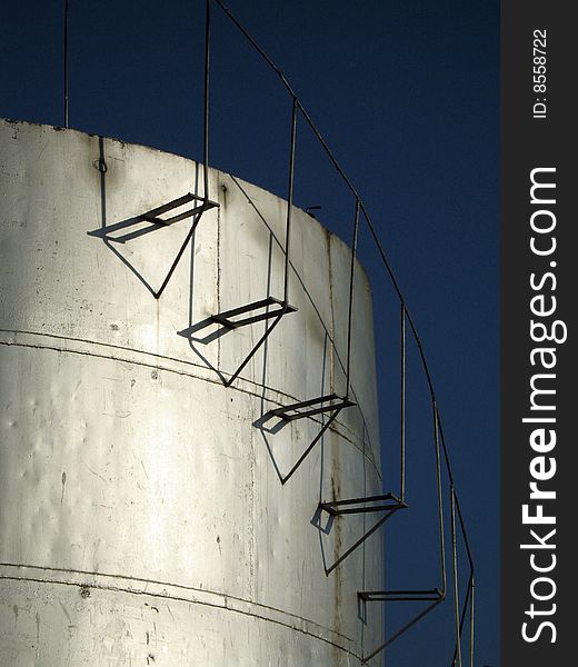 Cylindrical fuel storage tanks with staircase running along the side