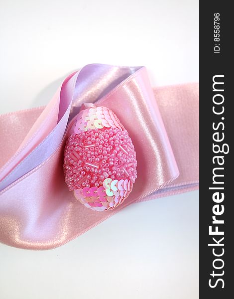 Pink easter  egg decorated a ribbon