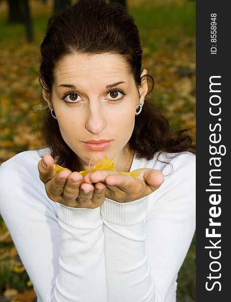 Portrait of pretty girl with autumn leaf