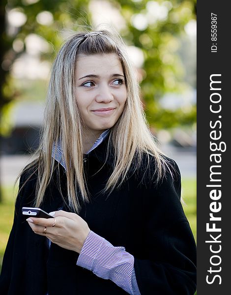 Portrait of cute young girl with phone