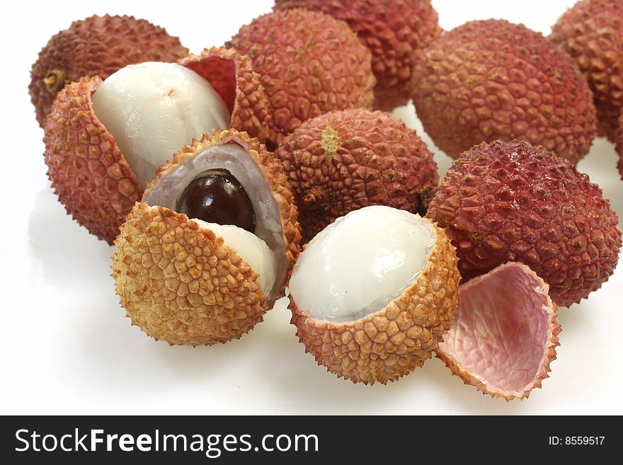 Closeup of fresh litchis over white background