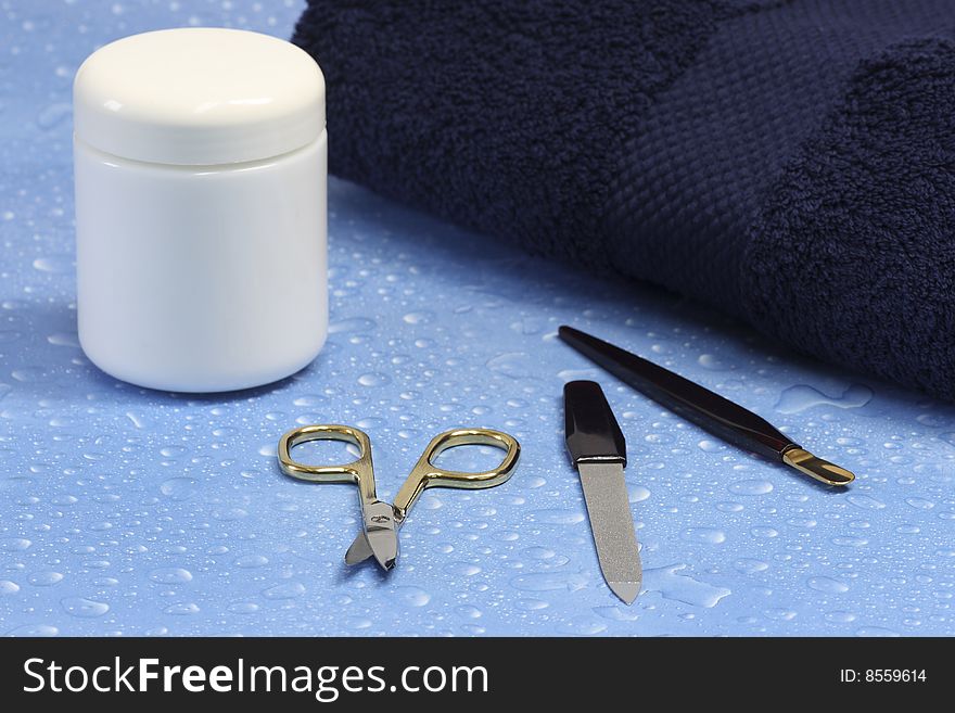 Manicure utensils over blue background