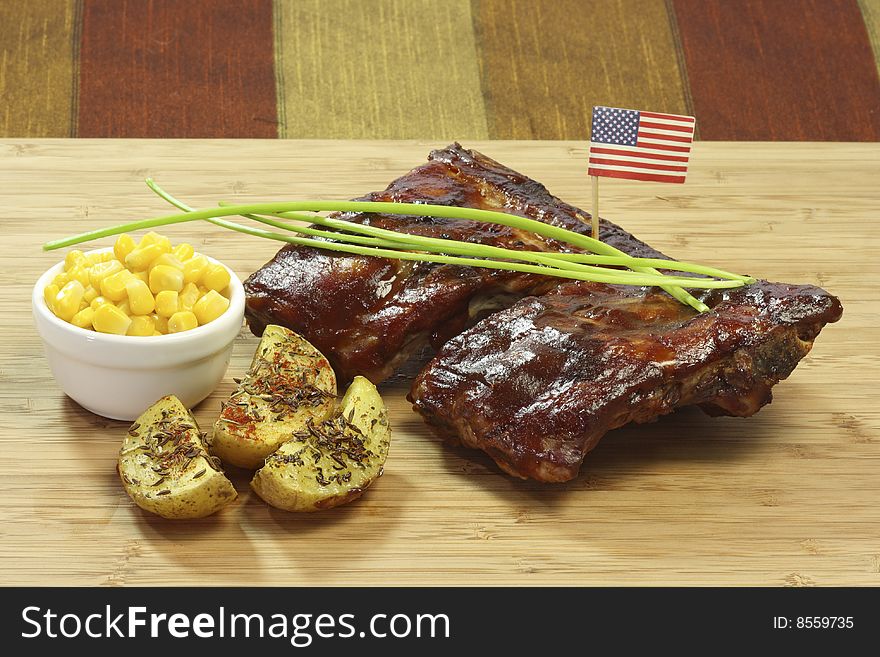 Grilled spare ribs with potatoes and corn