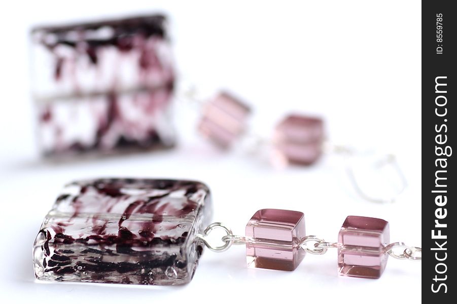 Violet earrings made by lampwork square and cubes on white background