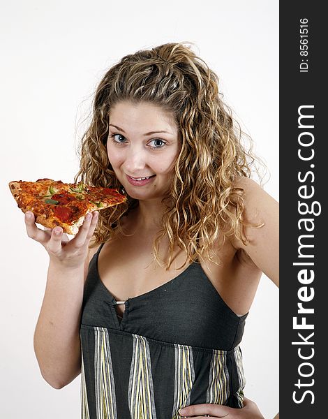 Sweet and pretty girl eating pizza slice