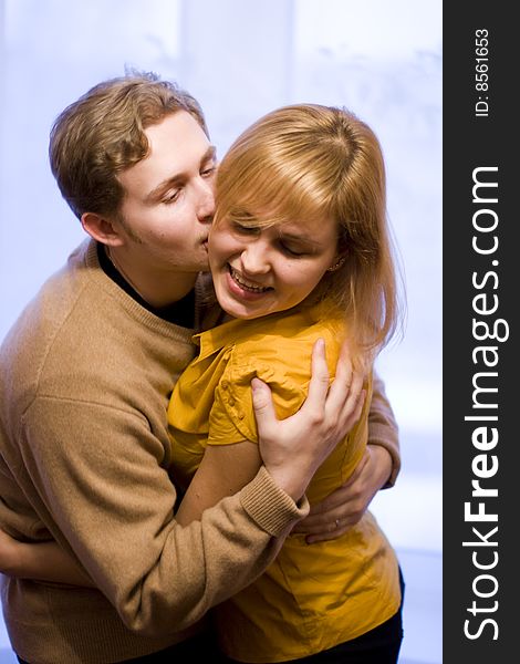 Happy young couple kissing. The girl and the young man closed eyes. Happy young couple kissing. The girl and the young man closed eyes.