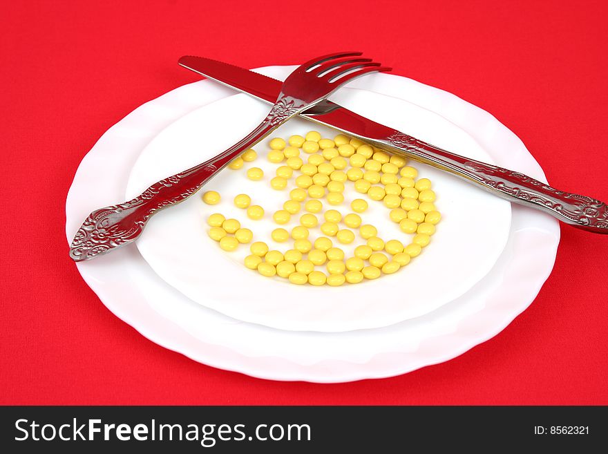 Plug, knife and tablets on a plate