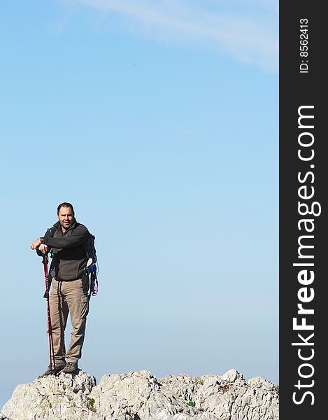 A handsome middle age hispanic latin man in a top of a in mountain hiking