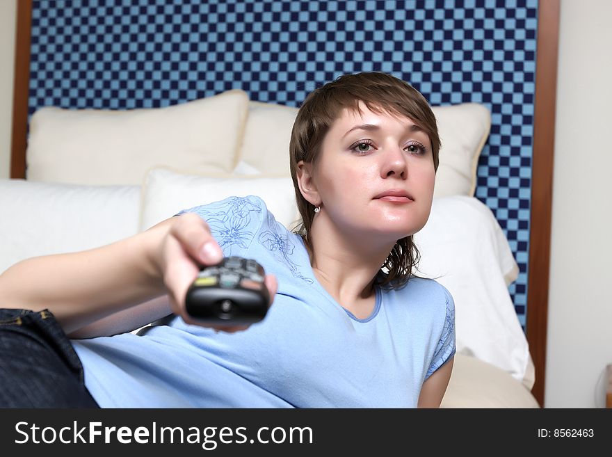 The girl resting on a bed in a hotel. The girl resting on a bed in a hotel