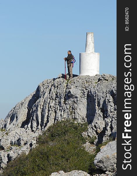 Man in a top of a in mountain hiking