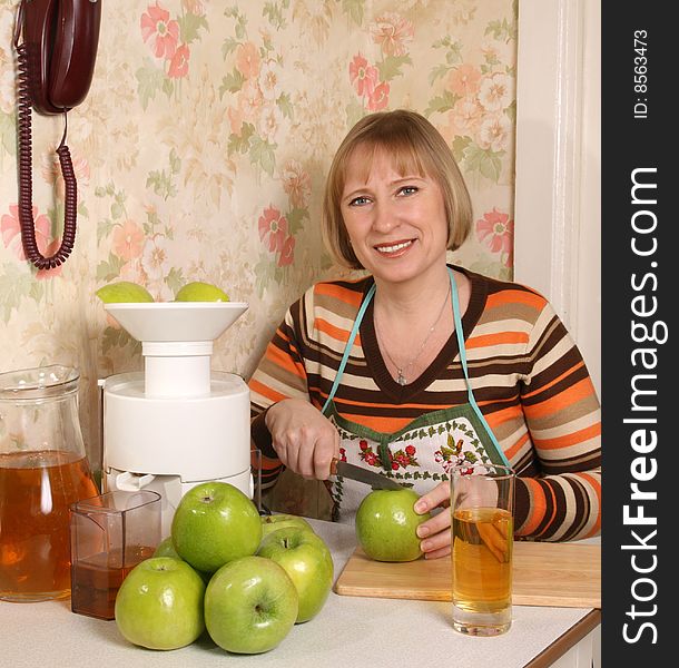 The young woman prepares for apple juice. The young woman prepares for apple juice