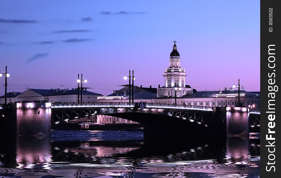 Image of a night city plot. The bridge through the river.