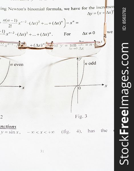 A pair of glasses on a maths teach book. A pair of glasses on a maths teach book