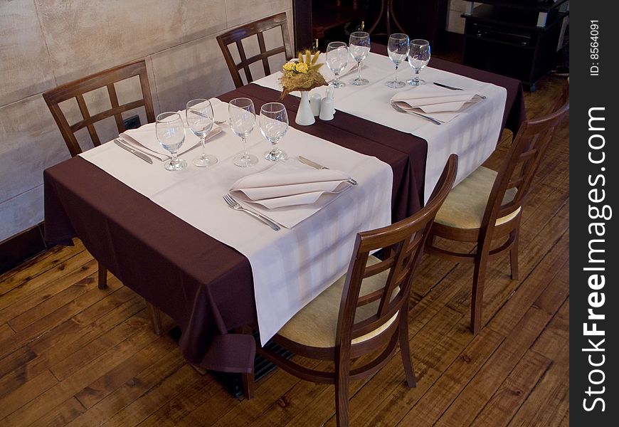 Tables with cutlery, plaits and glasses in Restaurant. Tables with cutlery, plaits and glasses in Restaurant