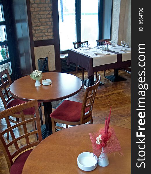 Round tables with ashtray and flower in restaurant. Round tables with ashtray and flower in restaurant