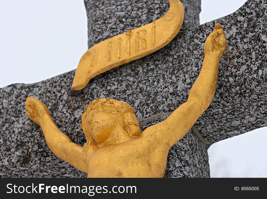Golden christ sculpture on the wayside cross