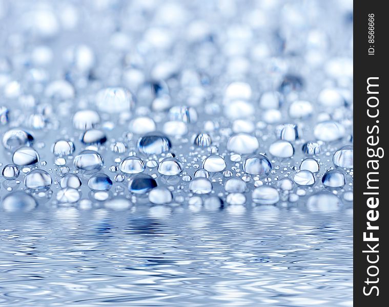 Blue droplets reflected in the water