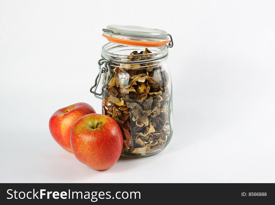 Jar full of wild mushrooms and red apples. Jar full of wild mushrooms and red apples