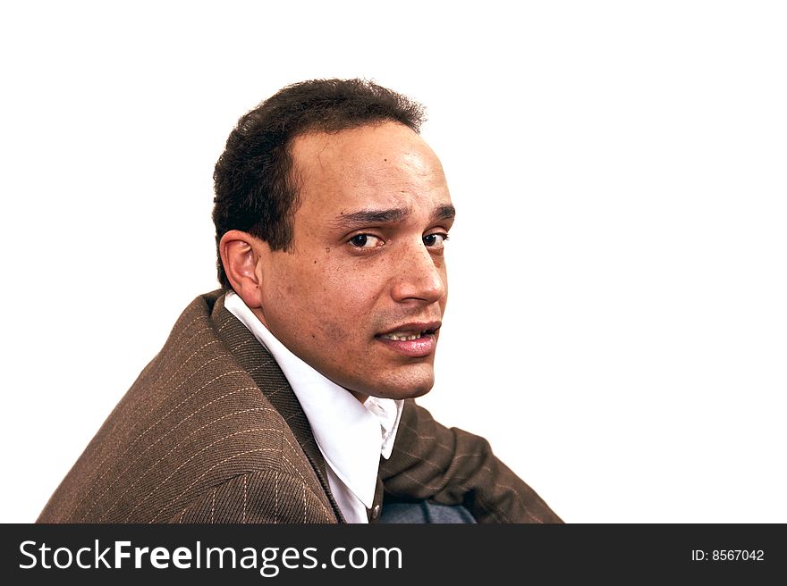 Serious over the shoulder look of african american male wearing dress shirt and suit coat against white background