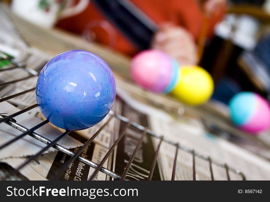 A blue Easter egg dries after painting. A blue Easter egg dries after painting