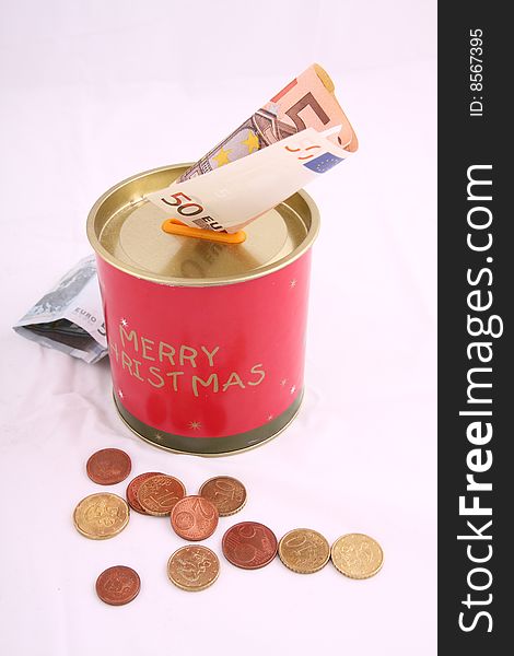 Christmas savings, euro bills and coins with velvet decorations