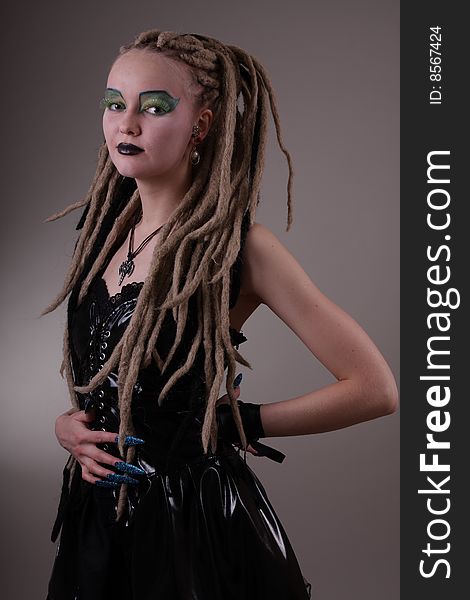 Young woman with dread locks and punk clothing