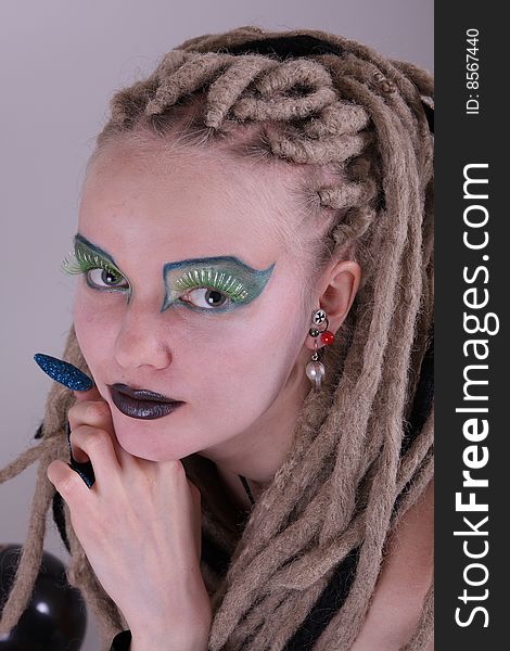 Young woman with dread locks and punk clothing